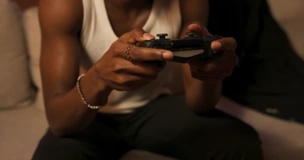 African American Man Relaxes Living Room Couch Playing Video Games — Stockvideo