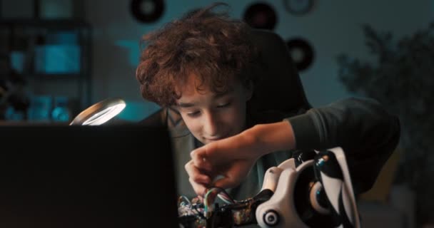 Portrait Boy Spending Time Room Desk Repairing Robot Screwing Screws — Stockvideo