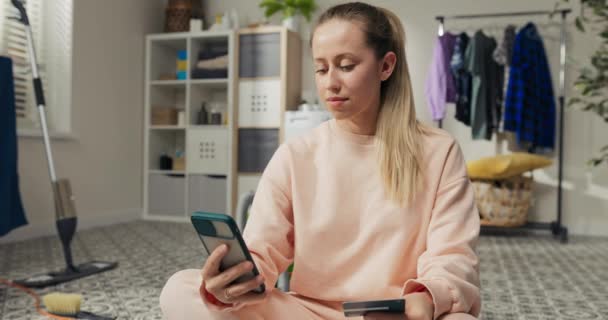 Woman Sweatpants Sits Floor Uses Cell Phone Listens Music Wireless — Stock video