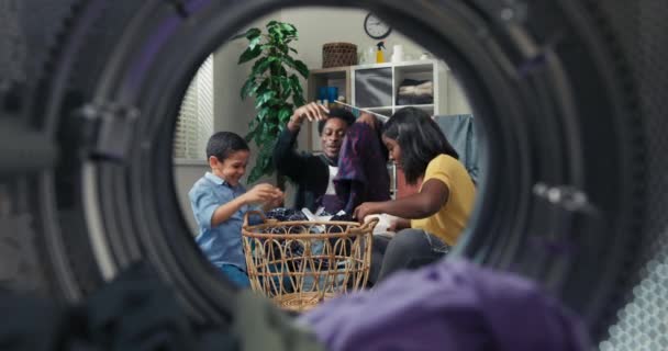 Mom Dad Son Sort Clothes Sitting Laundry Room Floor Fooling — Stockvideo