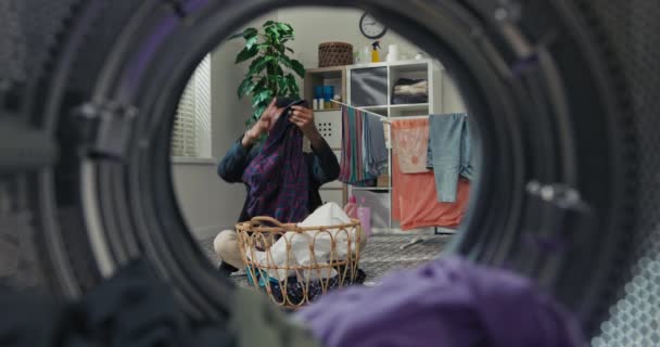 Handsome Young Man Folds Clean Clothes Sorts Laundry Student Sits — Stock videók