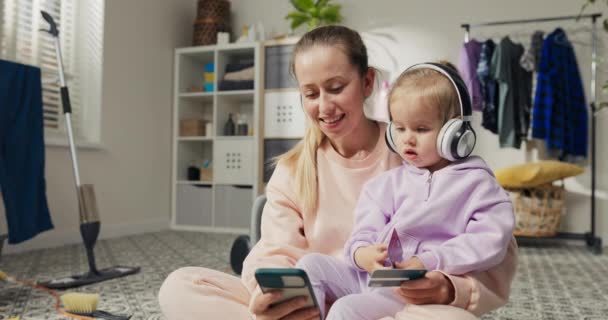 Woman Daughter Listen Music While Taking Break Doing Household Chores — Vídeos de Stock