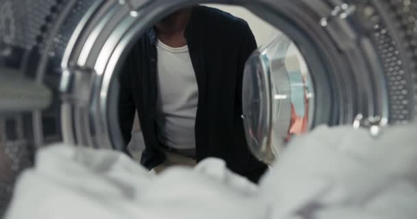 View Washing Machine Drum Man Approaches Machine Kneels Opens Door — Stockvideo