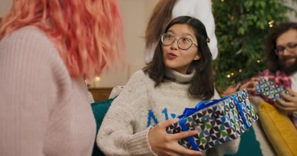 Christmas Party Friends Gathered Living Room Exchange Gifts Asian Looking — Stockvideo