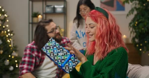 Christmas Party Full Swing Friends Unpack Gifts Girl Red Curly — Stock video