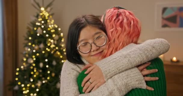 Young Asian Girl Glasses Hugs Childhood Friend Who Wearing Green — Stockvideo