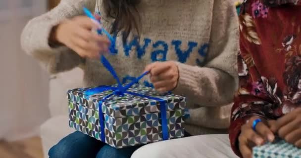 Christmas Party Young Asian Girl Glasses Sits Couch Unpacks Present — 图库视频影像