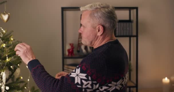 Gri Saçlı Üzgün Bir Adam Madalyayı Elinde Tutuyor Noel Ağacına — Stok video