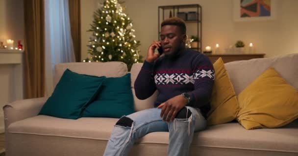 Afroamerykanin Siedzi Kanapie Rozmawia Przez Telefon Powiedziano Lot Domu Został — Wideo stockowe