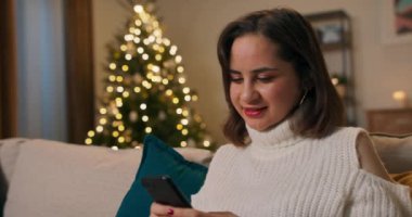 Gülümseyen bir kız Noel 'i evde yalnız geçirir. Kadın akşamları kanepede oturuyor, Noel ışıkları yanıyor ve sosyal ağlarda arkadaşlarıyla sohbet ediyor. Şakalar yapıyor..