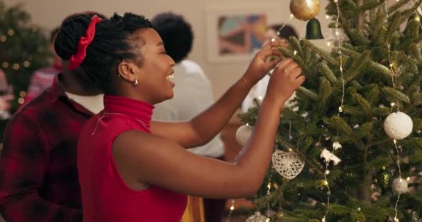 Girl African Appearance Decorates Christmas Tree Boyfriend Dressed Red Clothes — Stock Video