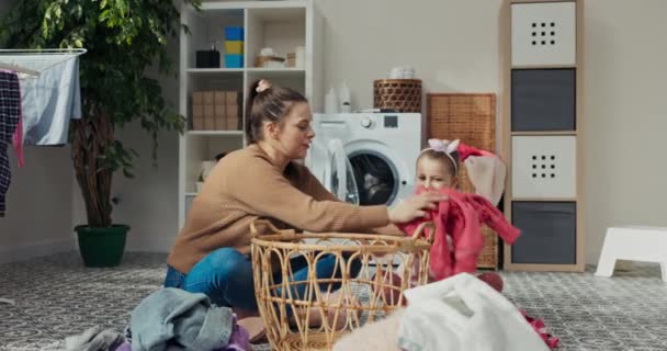 Little Girl Aunt Doing Laundry Sitting Bathroom Floor Pulling Dirty — Stock Video