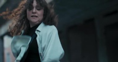 Sokak dansı yarışması sırasında dans eden genç kızların yüzlerinin yakın çekimi. Genç kız bol elbiseli, müzik eşliğinde çalmaktan hoşlanıyor..