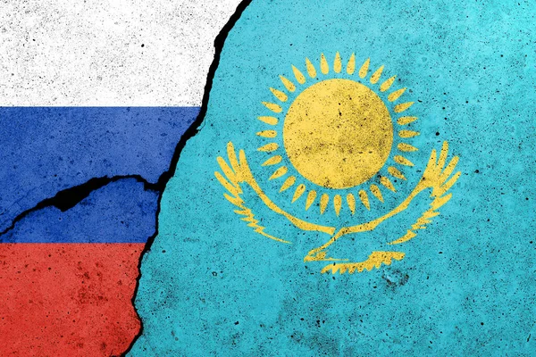 Russia and Kazakhstan flags painted on a concrete wall. Relationship between Kazakhstan  and Russia