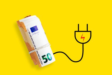 Euro banknotes on a yellow background. Energy crisis and expensive electricity, gas price. Big heating, gas and electricity bill