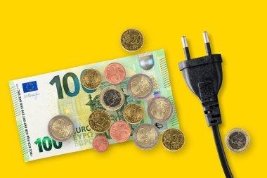 Euro banknotes on a yellow background. Energy crisis and expensive electricity, gas price. Big heating, gas and electricity bill