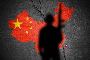 China and Taiwan flag map painted on a concrete wall with soldier shadow