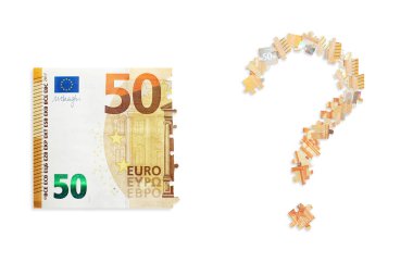 Puzzle made from fifty euro note and isolated on a white background.  Inflation and hyper inflation in Europe.