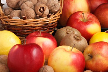 Kivi, elma, limon ve fındık bir tabakta birlikte yatar.