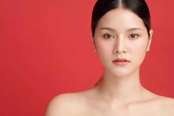 Beautiful young asian woman with clean fresh skin on red background, Face care, Facial treatment, Cosmetology, beauty and spa, Asian women portrait.