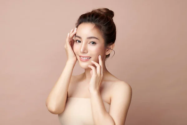 Beautiful young asian woman with clean fresh skin on beige background, Face care, Facial treatment, Cosmetology, beauty and spa, Asian women portrait.