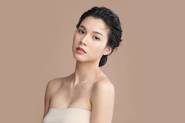 Beautiful young asian woman with clean fresh skin on beige background, Face care, Facial treatment, Cosmetology, beauty and spa, Asian women portrait.