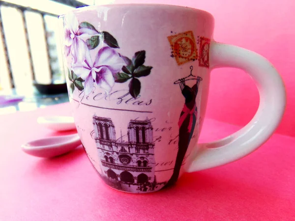 Little pink Paris coffee cup on a fuchsia table.