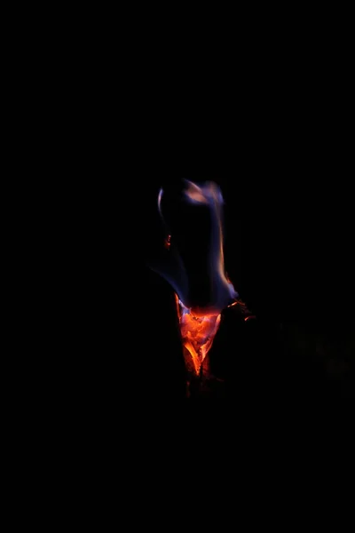 Smoke and embers in the fireplace on a black background.