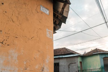 Traditional street of Leon Nicaragua. A corner building with adobe walls and clay tiles.