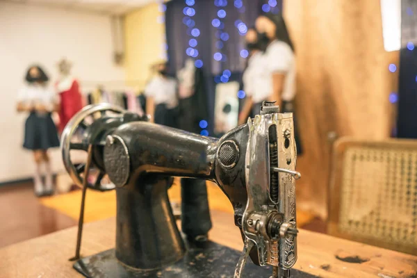 Unrecognizable Latina tailoring students inside a classroom