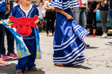 Unrecognizable children dressed in classic Nicaraguan clothes on the street of Managua