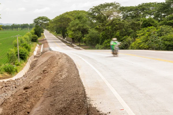 Motorcycle moving on a newly built hydraulic concrete road in Chinandega Nicaragua
