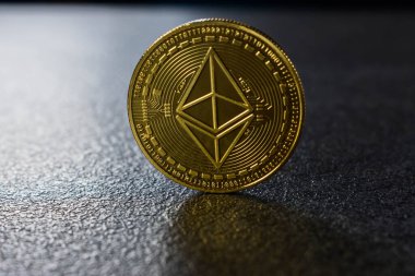 Ethereum coin placed on a black support, cryptocurrency