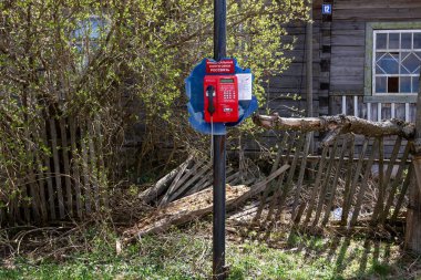 A broken payphone in a abandoned Russian village, a crooked homestead.High quality photo