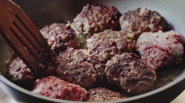 Frying meatballs, cutlets in oil On a frying pan, unhealthy food. Home cooking. Cooking. Meat dish. Juicy meat cutlets are fried in oil in a black frying pan High quality FullHD, Slow motion footage