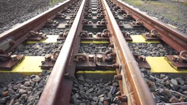 Railroad Tracks Passed Yellow Grooved Bearings Buried Small Shards Rock — Stock Video