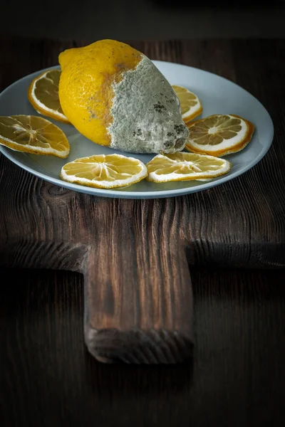 rotten lemon on a wooden board