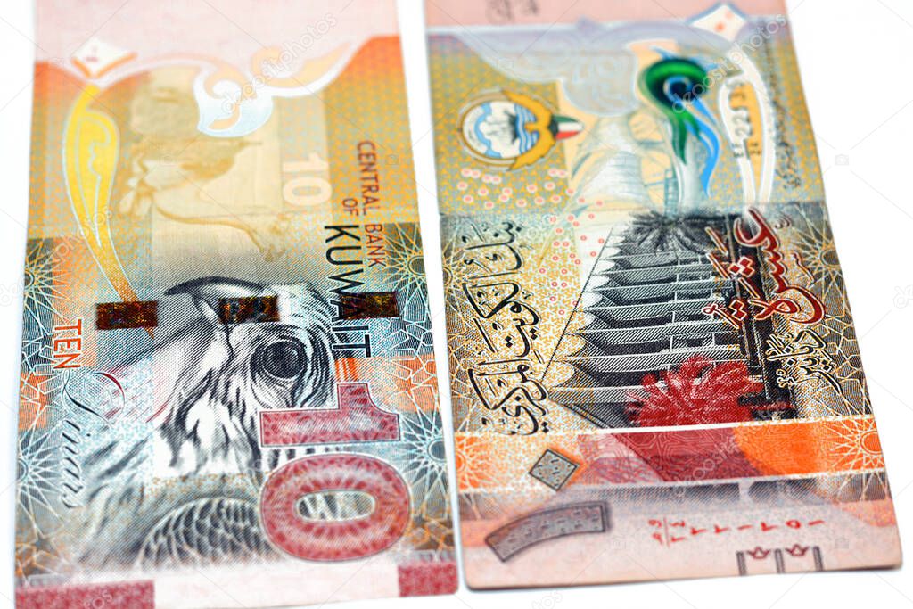 Ten Kuwaiti dinars bill banknote 10 KWD features The National Assembly of Kuwait, sambuk dhow ship, Falcon and camel dressed in a sadu saddle, Kuwaiti dinar is the currency of State of Kuwait isolated on white background
