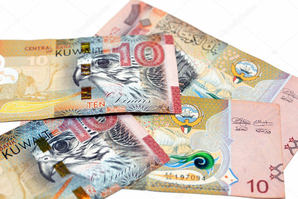 Ten Kuwaiti dinars bill banknote 10 KWD features The National Assembly of Kuwait, sambuk dhow ship, Falcon and camel dressed in a sadu saddle, Kuwaiti dinar is the currency of State of Kuwait isolated on white background