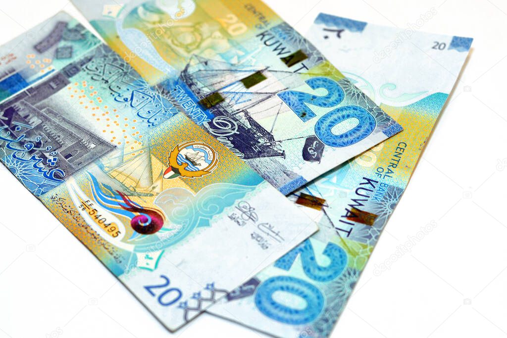 Twenty Kuwaiti dinars bill banknote 20 KWD features Seif Palace, a dhow ship, Kuwaiti pearl diver and Al-Boom traditional Kuwaiti dhow ship, Kuwaiti dinar currency of the State of Kuwait isolated on white background
