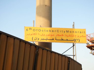 Giza, Mısır, 9 Aralık 2021: Mısır 'ın tek raylı taşıma sistemi için Arapça işaretli bir inşaat alanı, Arapça metnin çevirisi (6 Ekim şehir monoray tren projesi), seçici odaklı