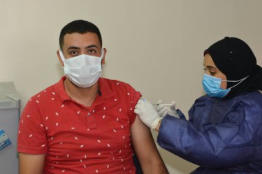 Kahire, Mısır. 31 Ağustos 2021: Kişiye koronavirüs aşısı, COVID-2019 aşısı, salgın hastalığa karşı aşı, Coronavirus aşısı, Covid-19 aşısı, virüsü kontrol altına almak için