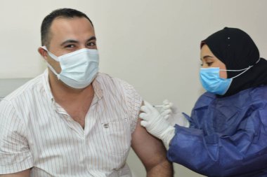 Kahire, Mısır. 31 Ağustos 2021: Kişiye koronavirüs aşısı, COVID-2019 aşısı, salgın hastalığa karşı aşı, Coronavirus aşısı, Covid-19 aşısı, virüsü kontrol altına almak için