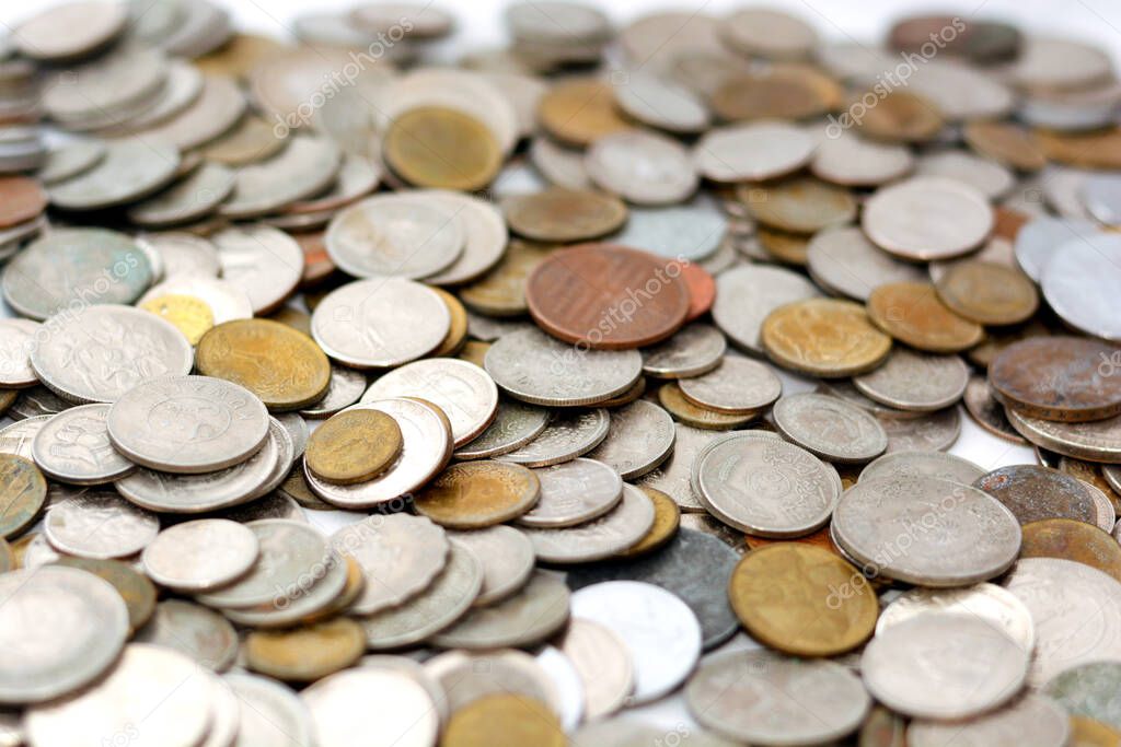 Background of various coins from many countries and different values, vintage retro, selective focus of old coins currency from multiple countries and different times, old coins from around the world