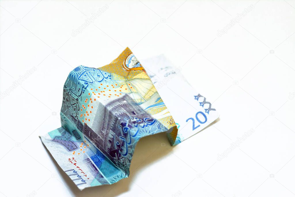 Selective focus of crumpled Kuwaiti money of 20 KWD twenty Kuwaiti dinars bill banknote isolated on white background, wrinkled dinar cash bill banknote, economy inflation concept