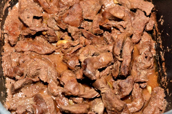 Selective focus of beef liver sliced in pieces and cooked with oil, white vinegar, black pepper, salt, spices, coriander and garlic, Egyptian cuisine of Alexandrian liver recipe ready to be served