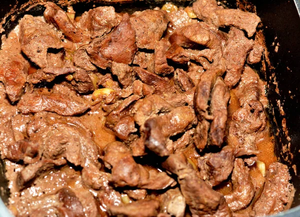 Selective focus of beef liver sliced in pieces and cooked with oil, white vinegar, black pepper, salt, spices, coriander and garlic, Egyptian cuisine of Alexandrian liver recipe ready to be served