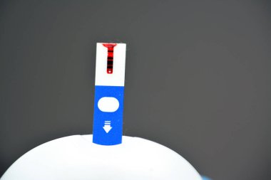 Evdeki diyabetik hastaları takip etmek ve onlar için ilaç dozlarını ve ilaçlarını ayarlamak için glikoz izleme cihazına yerleştirilmiş kullanılmış bir kan glikozu elektronik test şeridi, seçici odaklanma