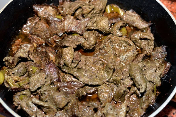 Grilled beef liver sliced in pieces and cooked with oil, white vinegar, black pepper, salt, spices, coriander and garlic, Egyptian cuisine of Alexandrian beef liver recipe ready to be served