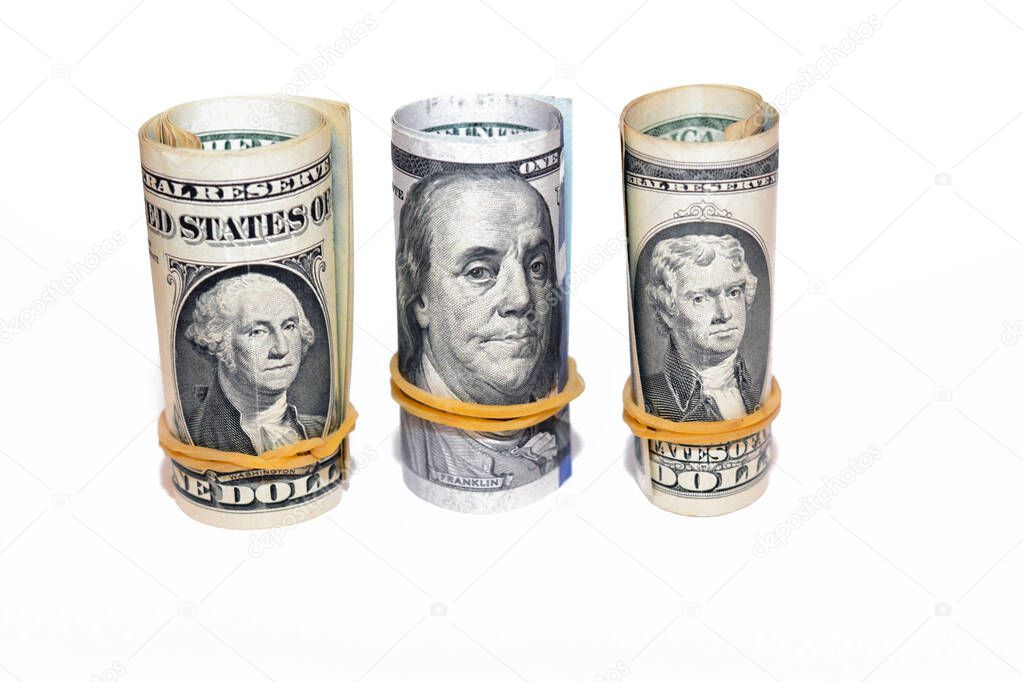 Pile of American dollars rolls isolated on white background, bundles of USA money banknotes rolled up with rubber bands in a raw of 1, 2 and 100 $, one, two and one hundred dollars bills cashmoney